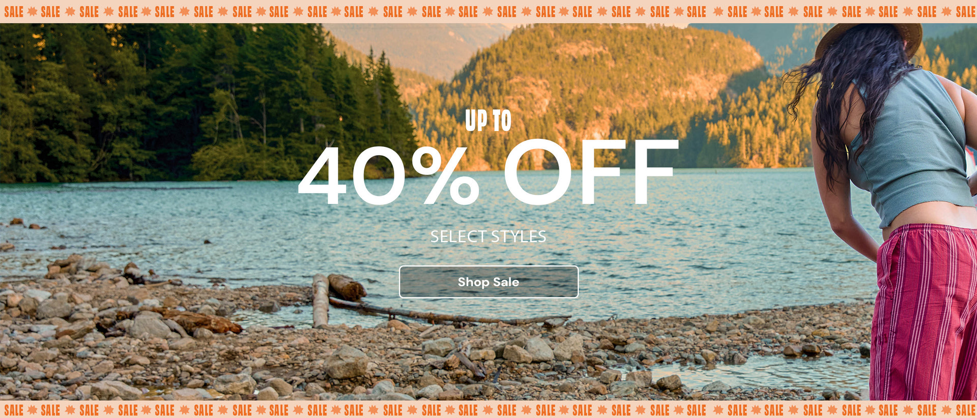 JanSPort Promotional banner with 'Up to 40% Off' text over a scenic background of a woman by a lake.
