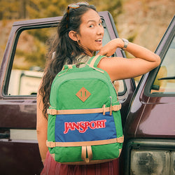 JanSport Retro Seattle Pack in Jelly Kelly colour worn by a smiling girl